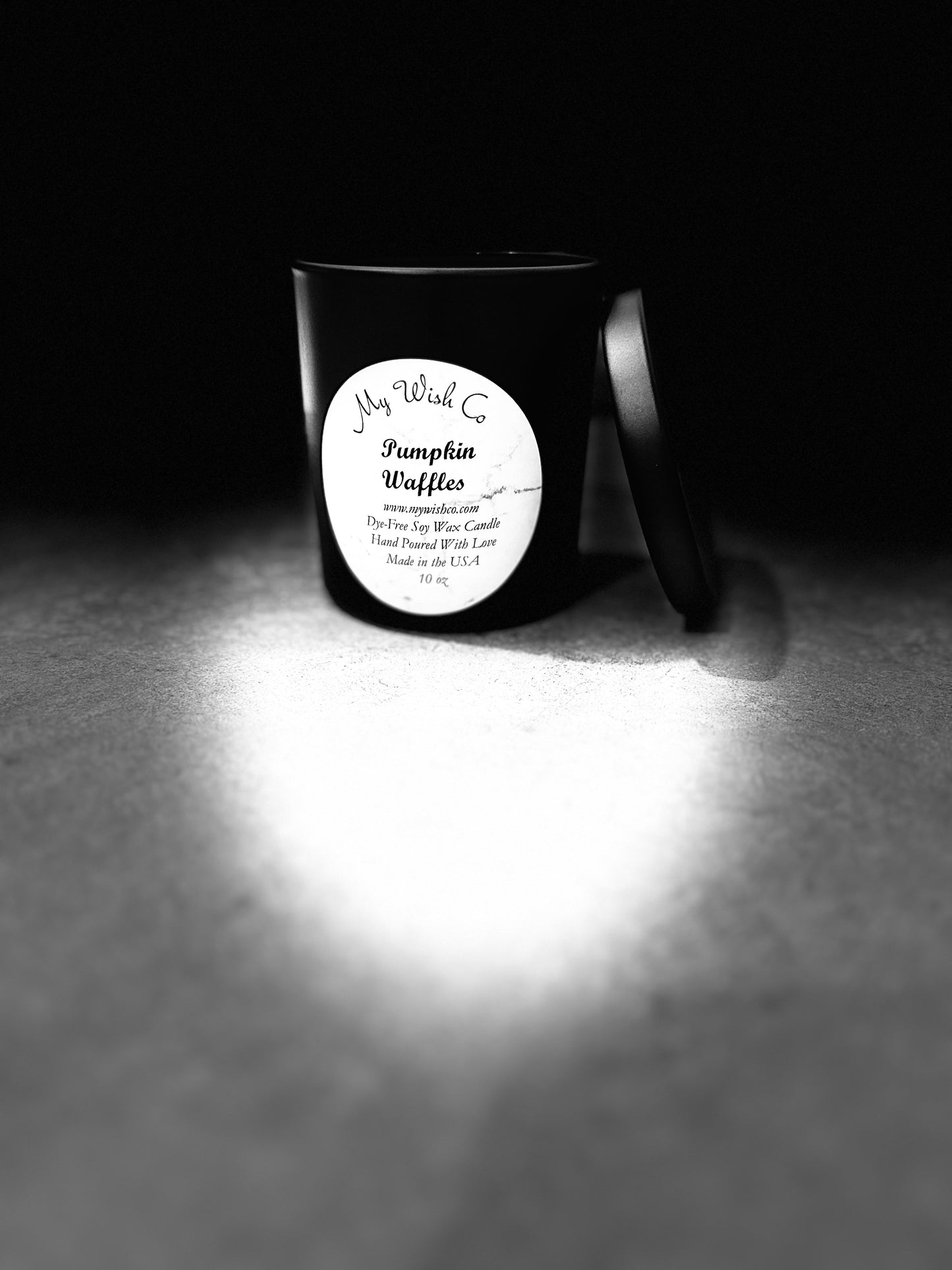 Candle with a label on a dark background