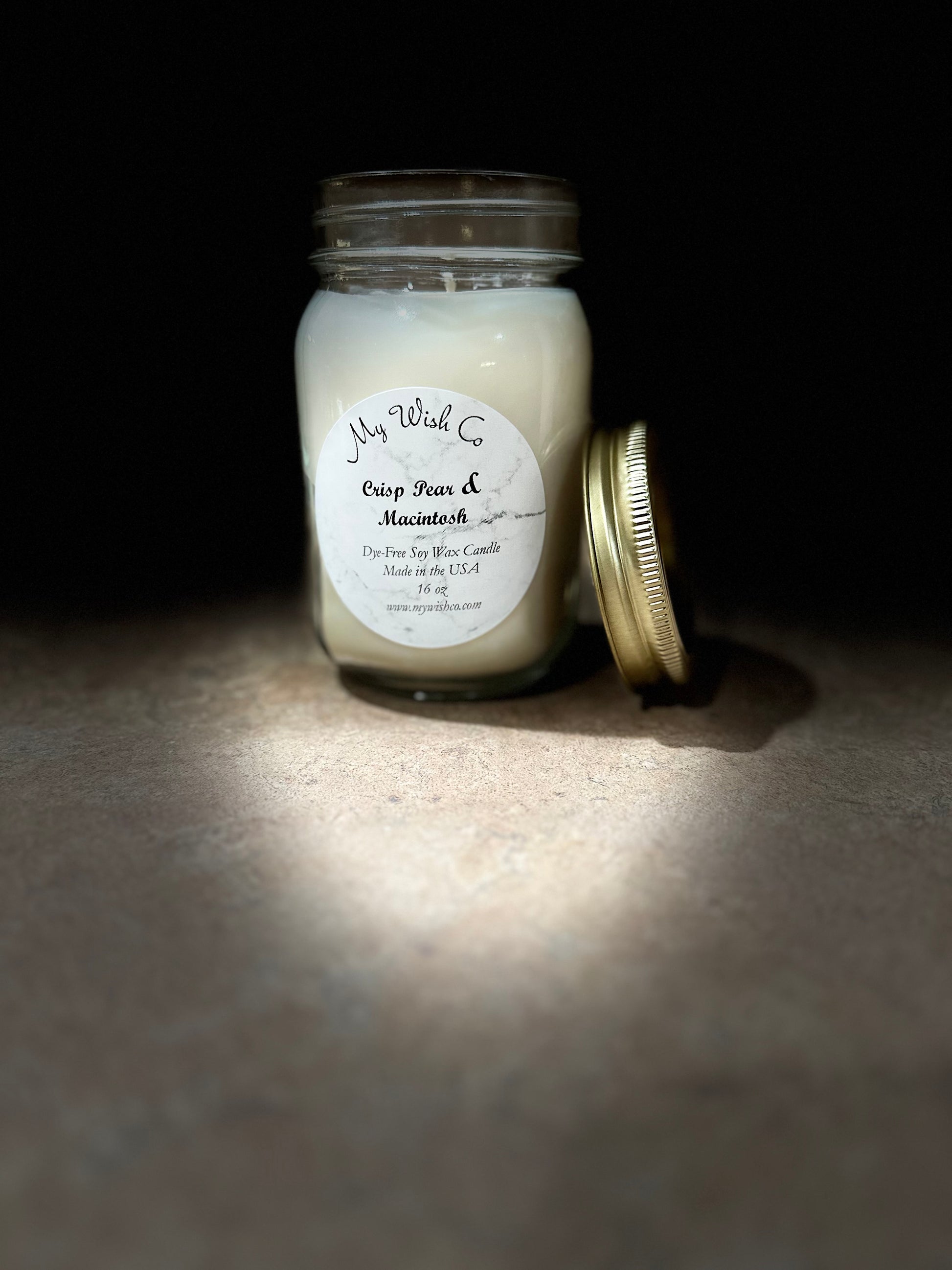 Candle jar with a label on a dark background