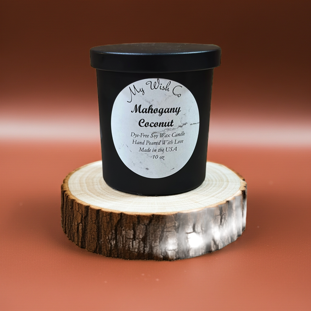 Black candle with a label on a wooden stand against a brown background