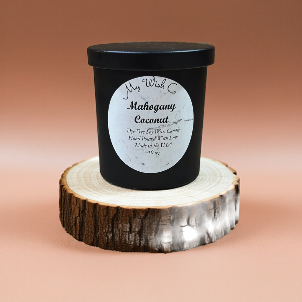 Black candle with a white label on a wooden stand against a brown background