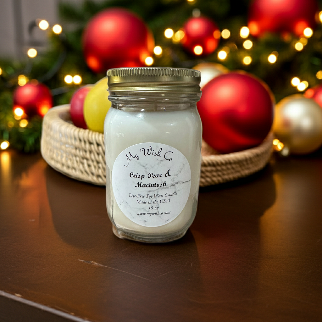 Jar of candle with a Christmas-themed background featuring ornaments and lights.