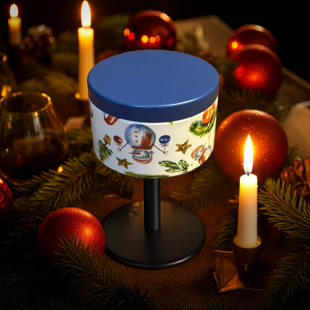 Decorative lamp with festive design surrounded by candles and ornaments