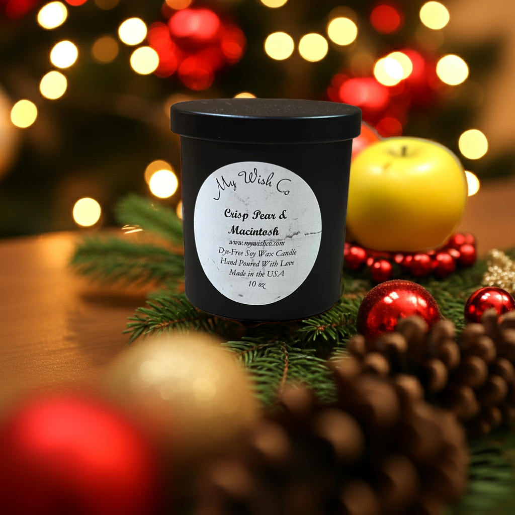 Black candle with a label on a table with Christmas decorations